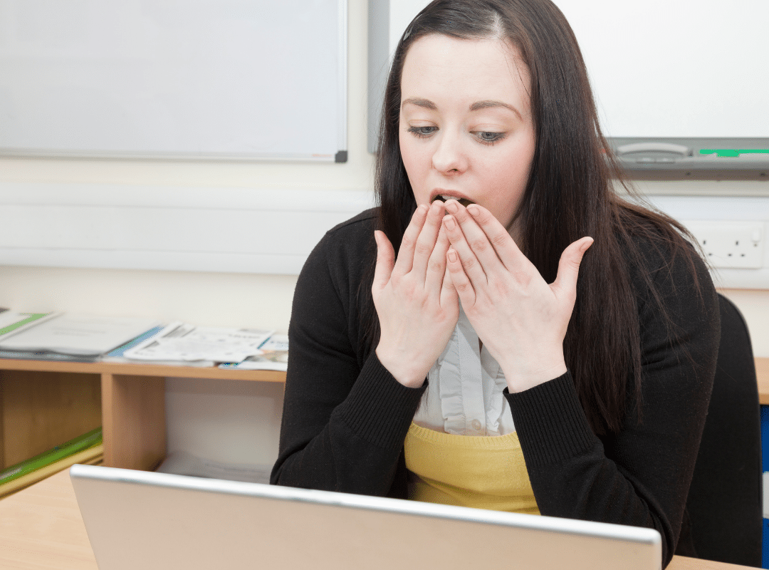 employee-looking-at-offensive-message-email-on-device